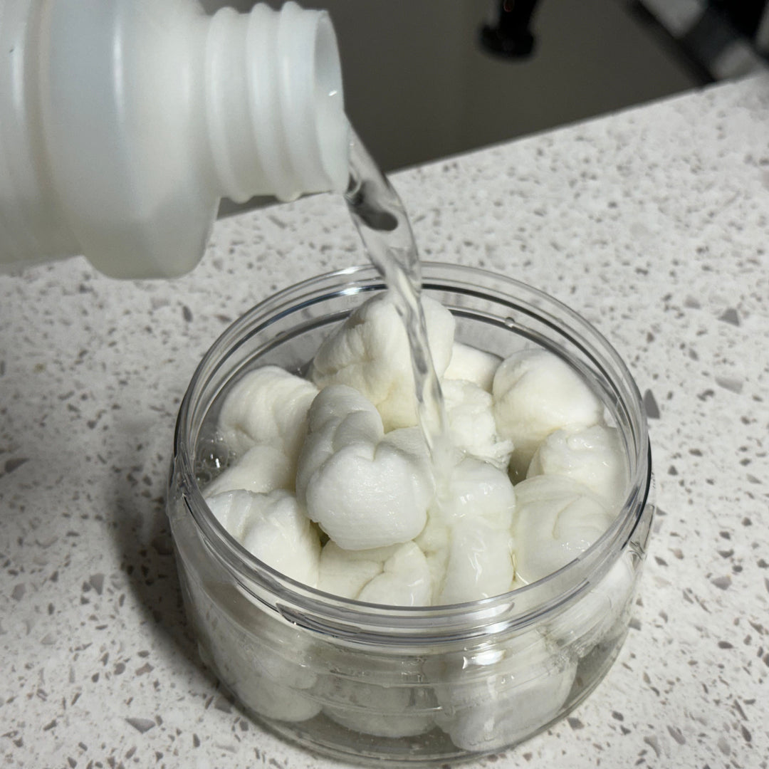 Soaking compressed cleaning cloths to expand them